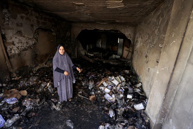 <p>A woman stands inside a destructed house caused by the Israeli forces attacks in Jenin, West Bank </p>