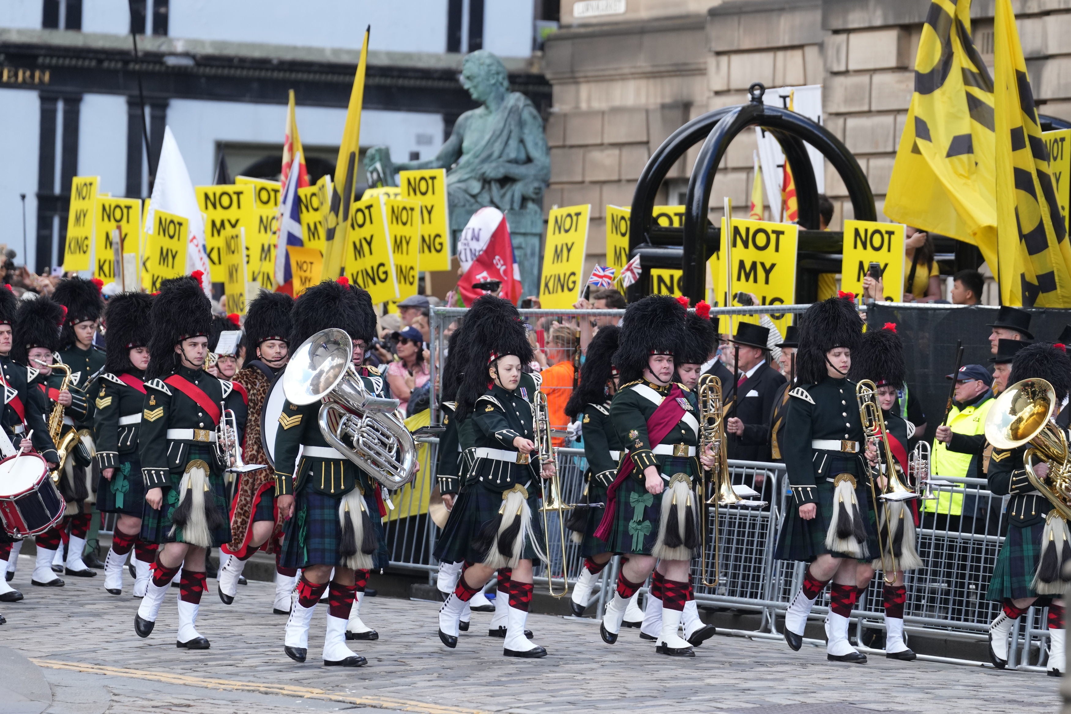 The Combined Cadet Force Pipes and Drums and the Cadet Military Band pass protesters