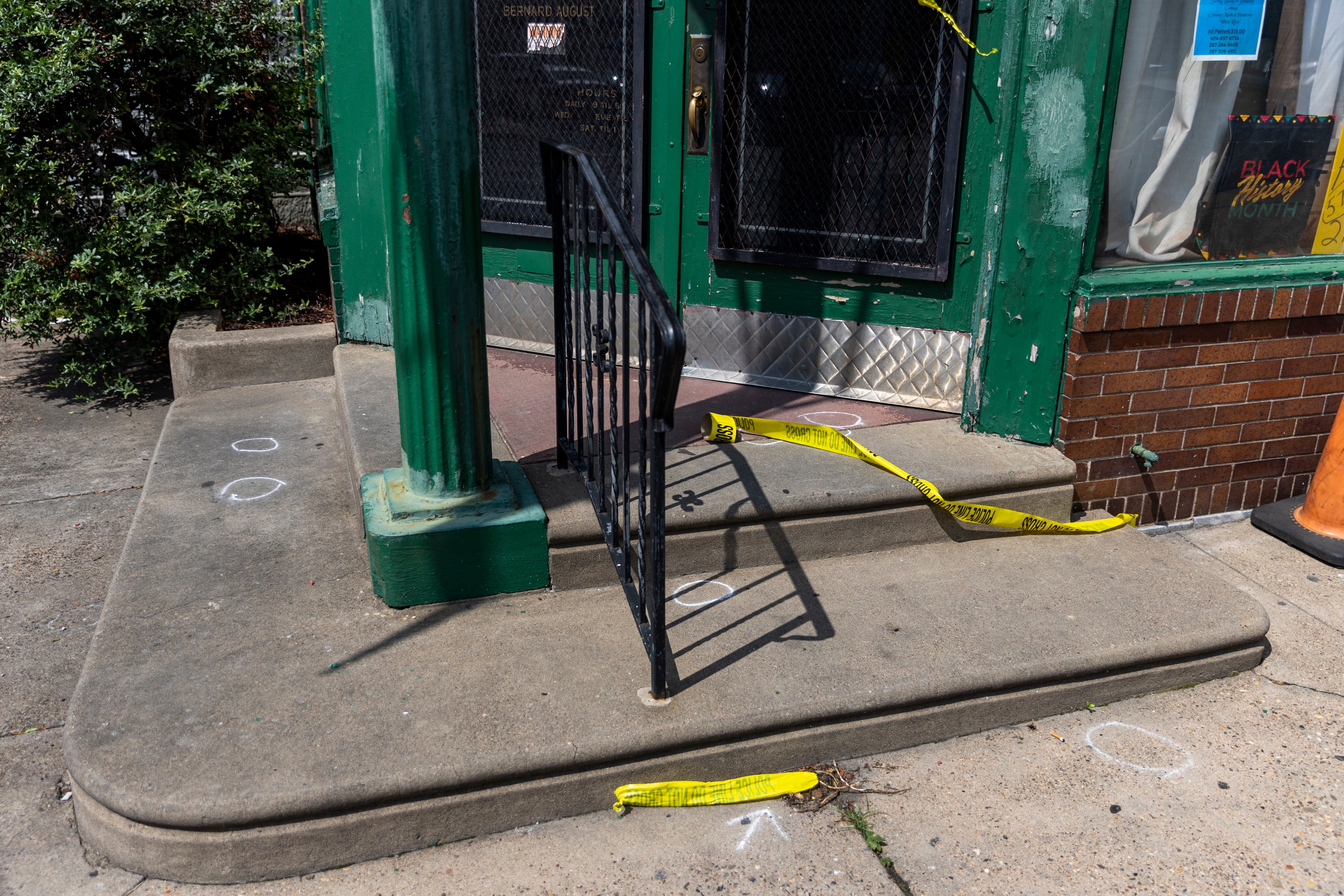 Evidence markers and police tape are left at the scene of a Monday night shooting in Philadelphia