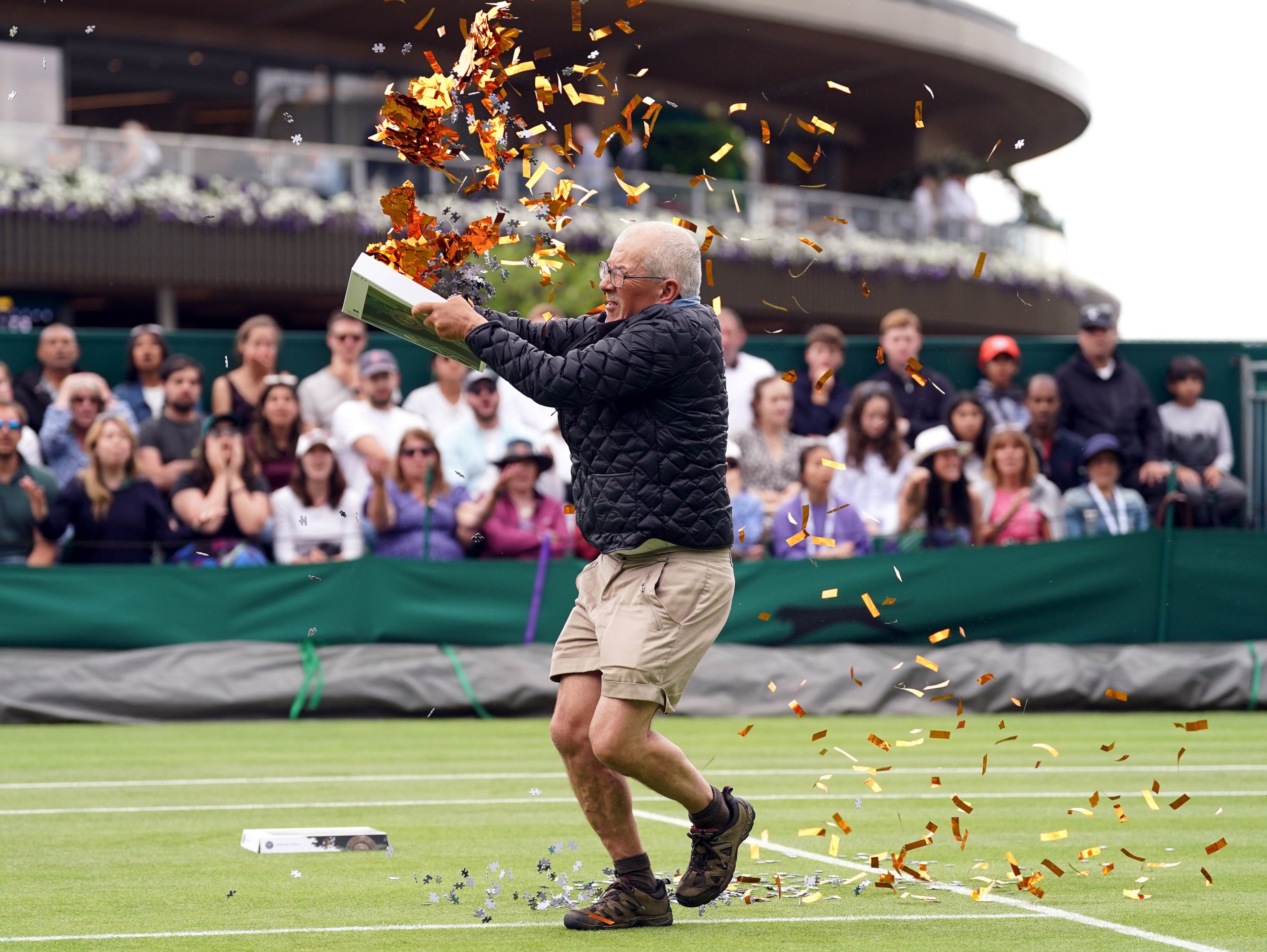 A protester throws confeti during Boulter’s first-round match with Daria Saville