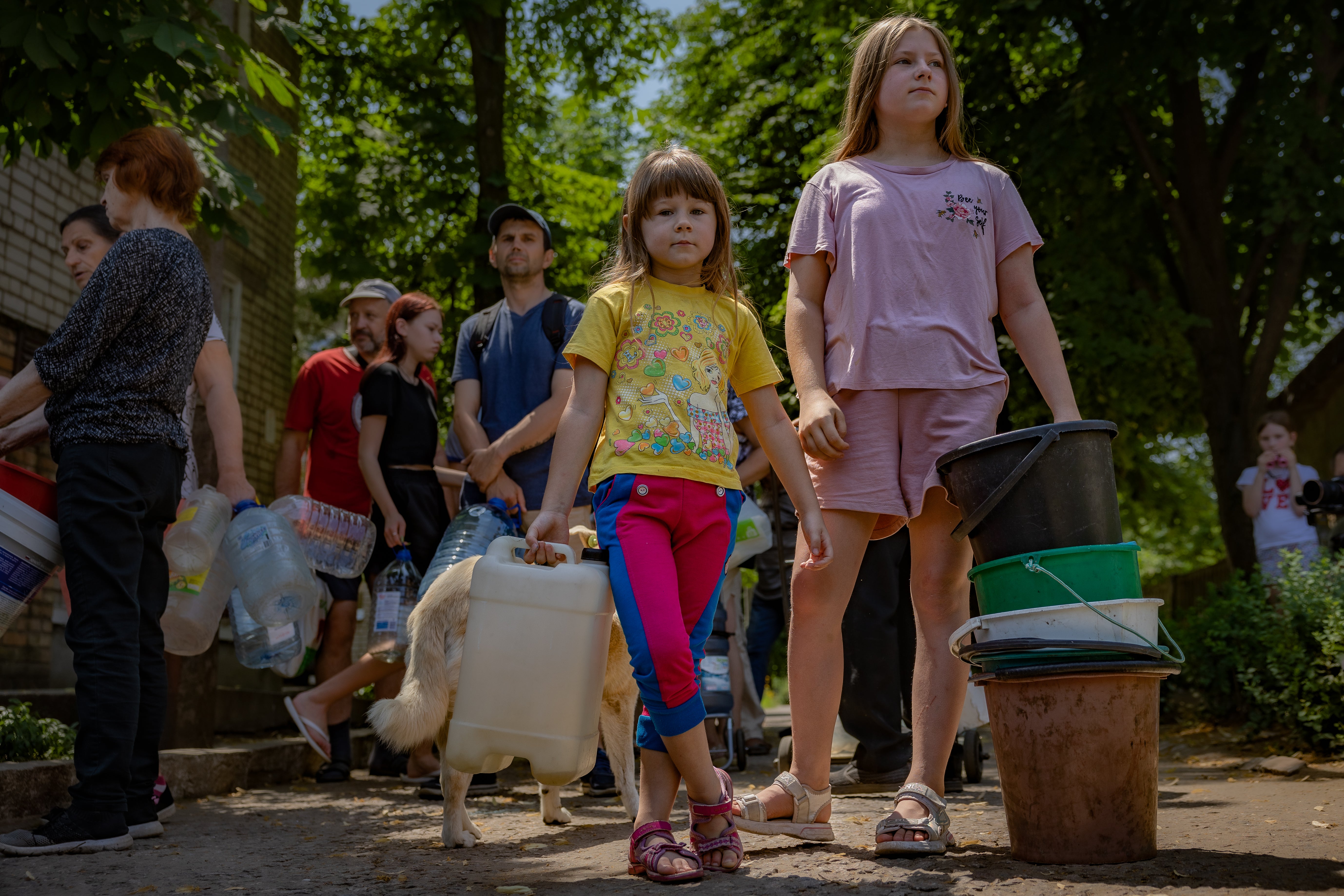 Children risk being shelled in a queue for water in the centre of Nikopol, which lies in the shadow of Europe’s largest nuclear power plant