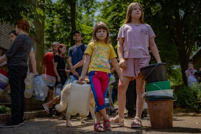<p>Children risk being shelled in a queue for water in the centre of Nikopol, which lies in the shadow of Europe’s largest nuclear power plant </p>