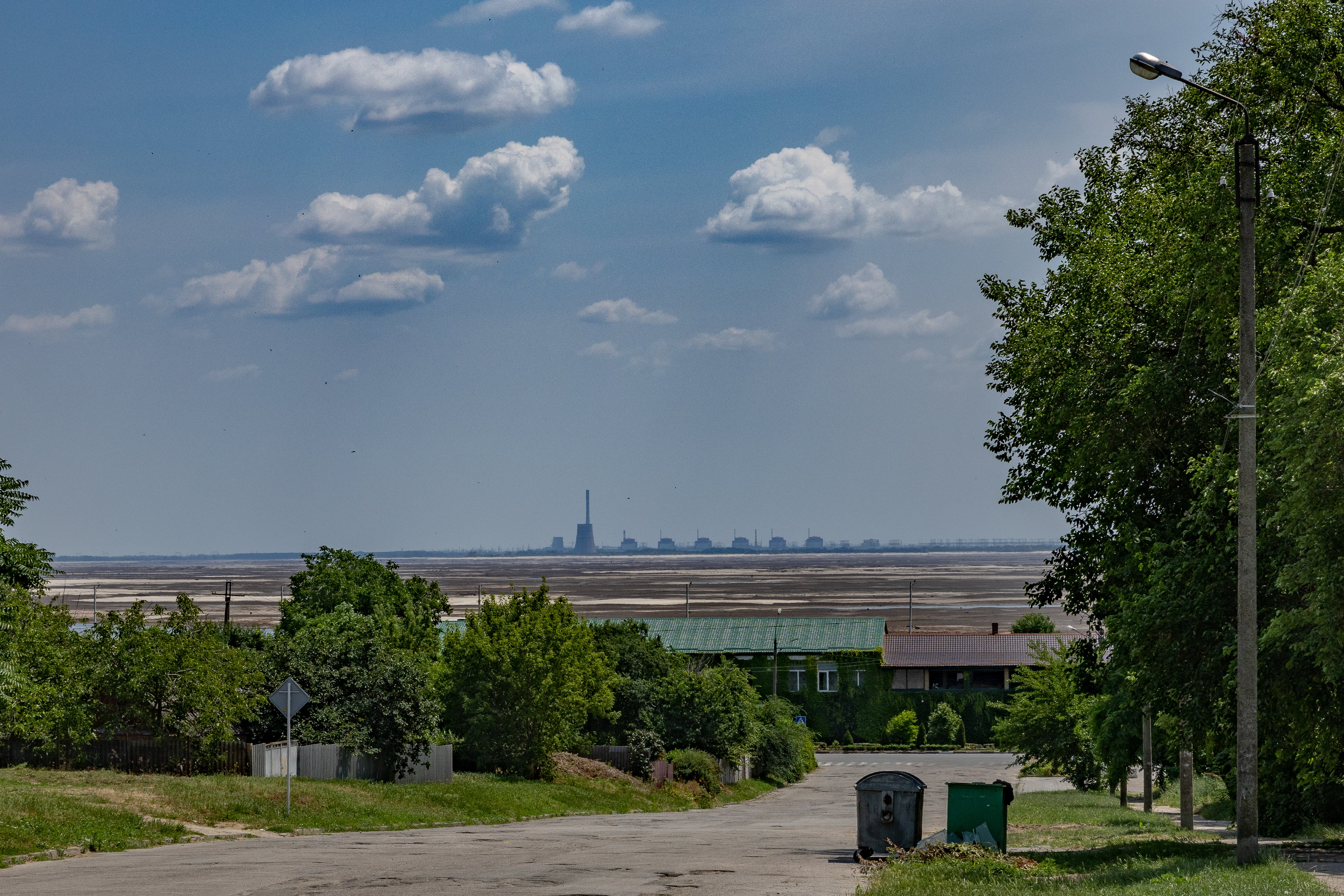 The Zaporizhzhia nuclear power plant overlooks the now-dry Kakhovka reservoir and the city of Nikopol