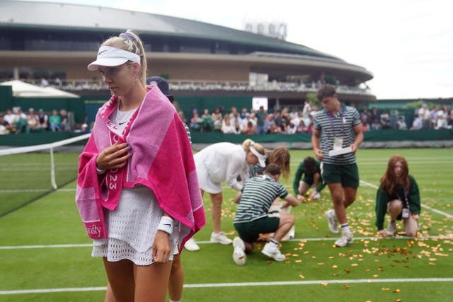 Katie Boulter looks on as ground staff clear confetti from court 18 after a Just Stop Oil protester invaded the court (Adam Davy/PA)