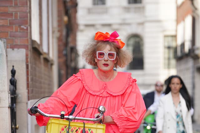 Sir Grayson Perry dons neon, tiered baby-doll dress for Spectator summer party (Lucy North/PA)