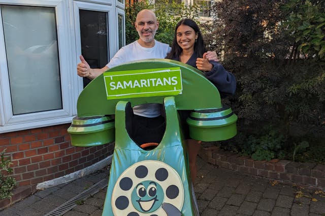 Dave Lock, who will captain the Samaritans team for the TCS London Marathon 2024, with his daughter Isabella and his telephone costume (Dave Lock/PA)