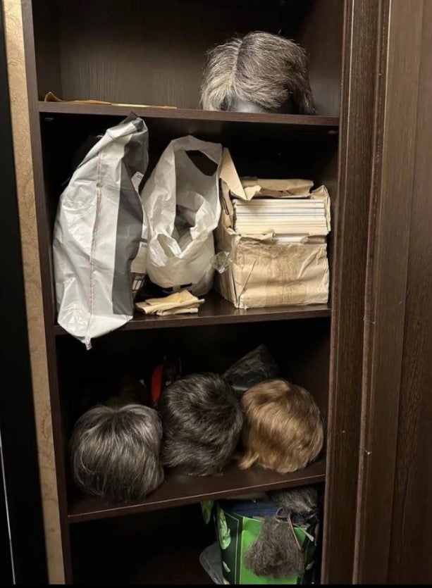 <p>A wardrobe full of wigs were also uncovered, with colours ranging from grey to a mousy brown</p>