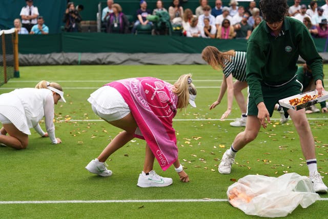 Tennis player Katie Boulter helped ground staff clear confetti from court 18 at Wimbledon (Adam Davy/PA)