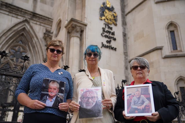 Emma De Saint Esteban, Sioux Vosper and Mandy Philips hold up pictures of their relatives who died outside the Royal Courts of Justice in London, where the Cabinet Office is bringing a challenge over the UK Covid-19 Inquiry’s request for materials (Lucy North/PA)