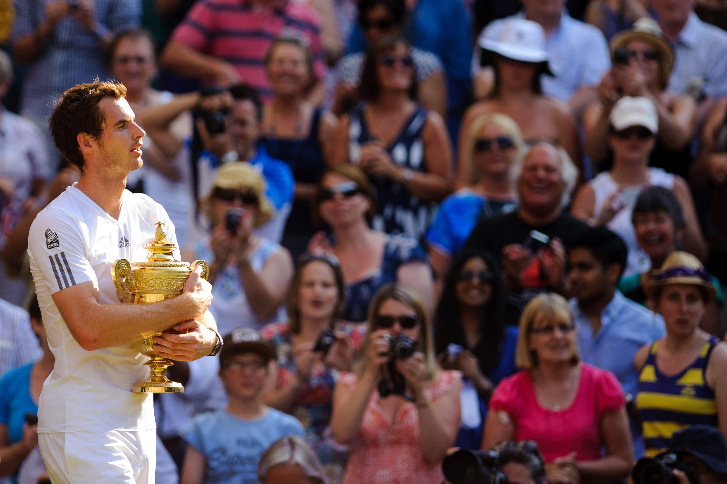 Andy Murray hugs the Wimbledon trophy 10 years ago (Dominic Lipinski/PA)