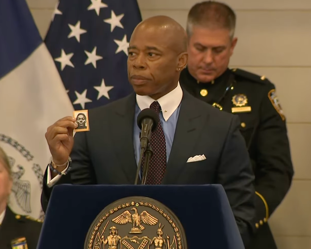 New York Mayor Eric Adams holds up a photograph of NYPD officer Robert Venable, who was killed in the line of duty in 1987, at an NYPD Medal Ceremony in 2022