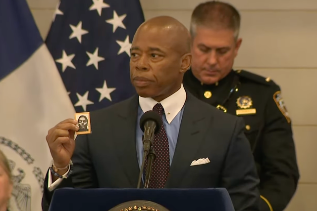 <p>New York Mayor Eric Adams holds up a photograph of NYPD officer Robert Venable, who was killed in the line of duty in 1987, at an NYPD Medal Ceremony in 2022</p>