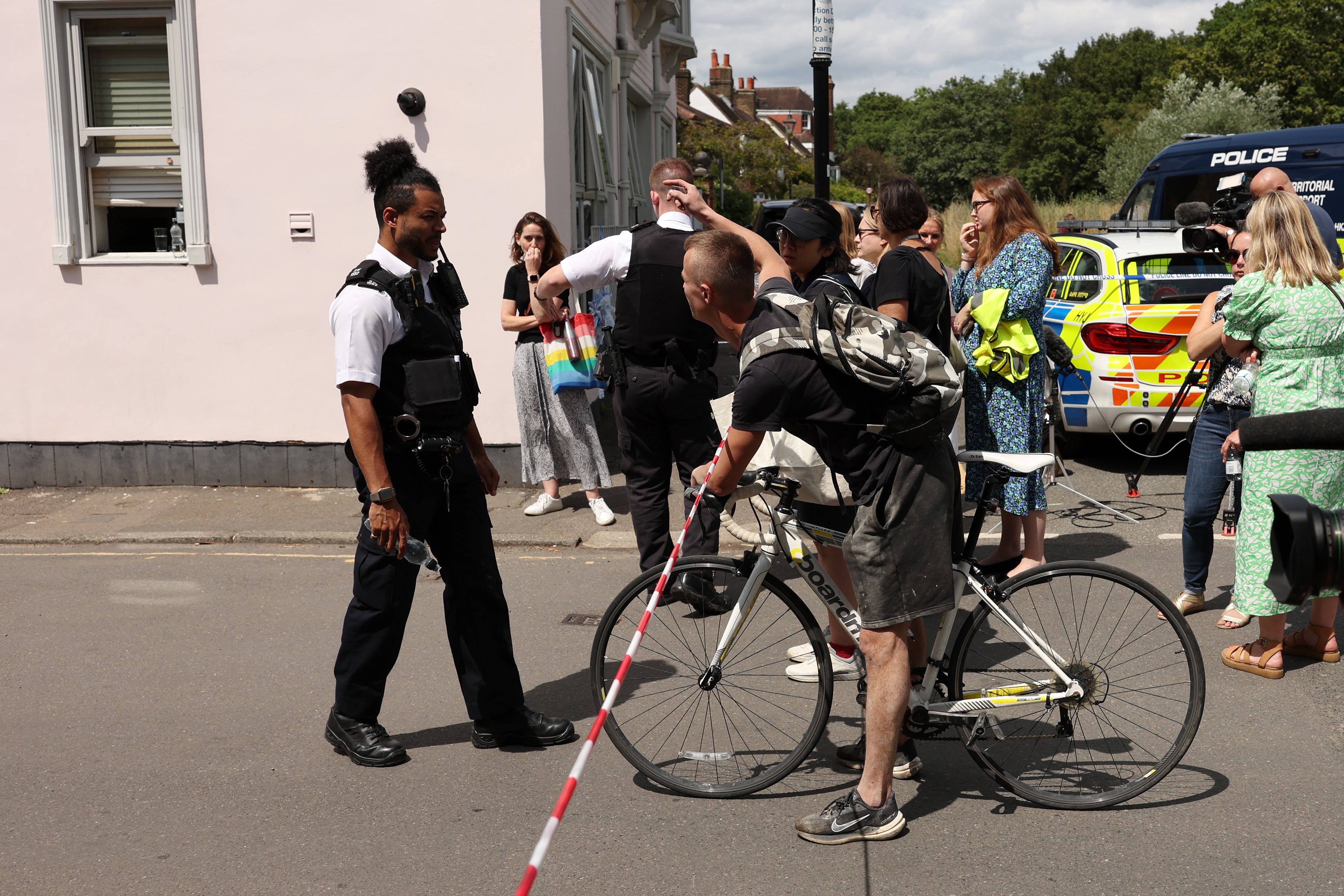 pPeople gather outside a cordon at the scene of a car crash at a school on 6 July 2023 in Wimbledon, England/p
