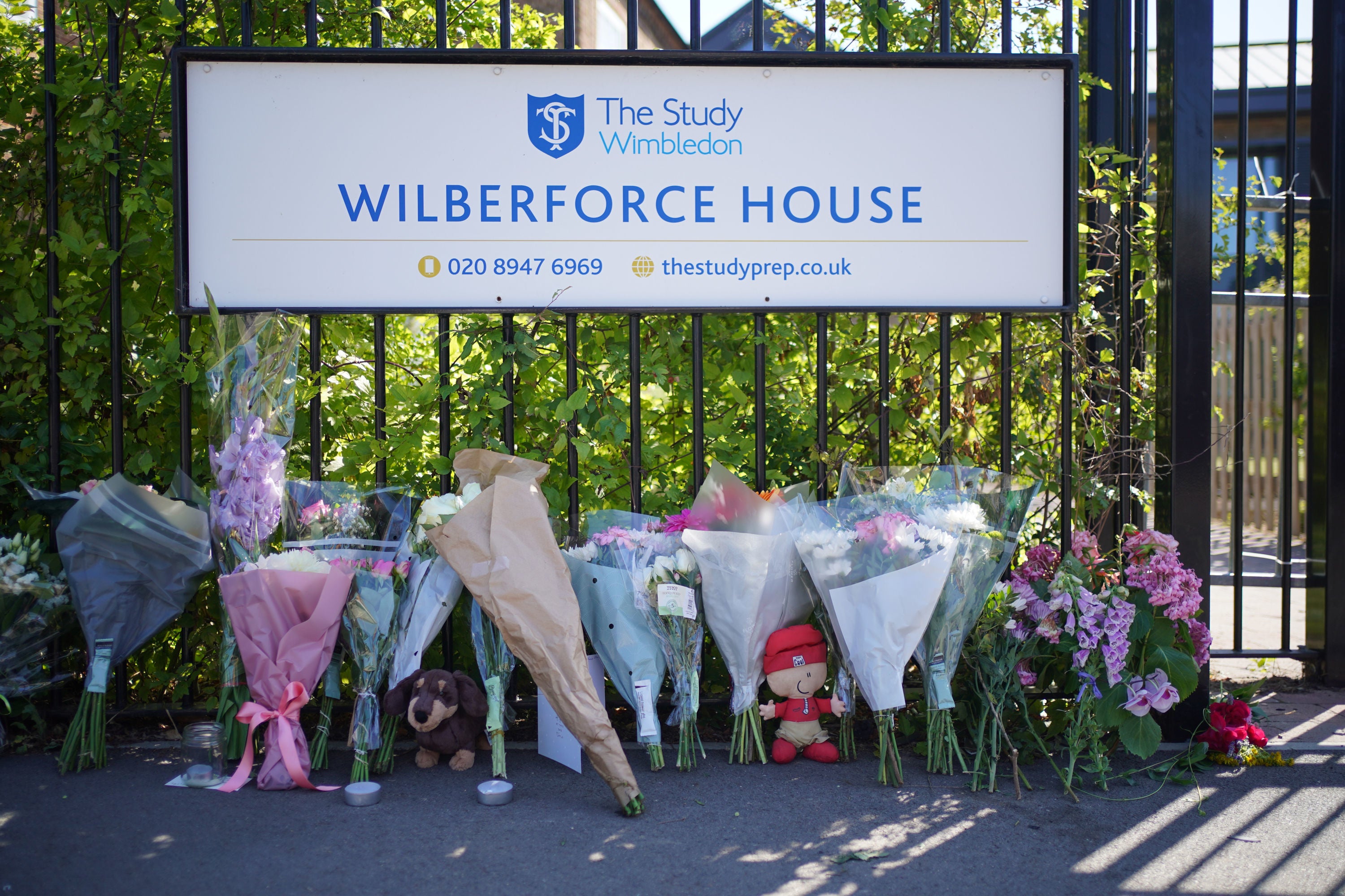 Flowers and toys placed outside the Study Preparatory School in Wimbledon, south-west London, after a Land Rover crashed into the girls' prep school building on the last day of term.