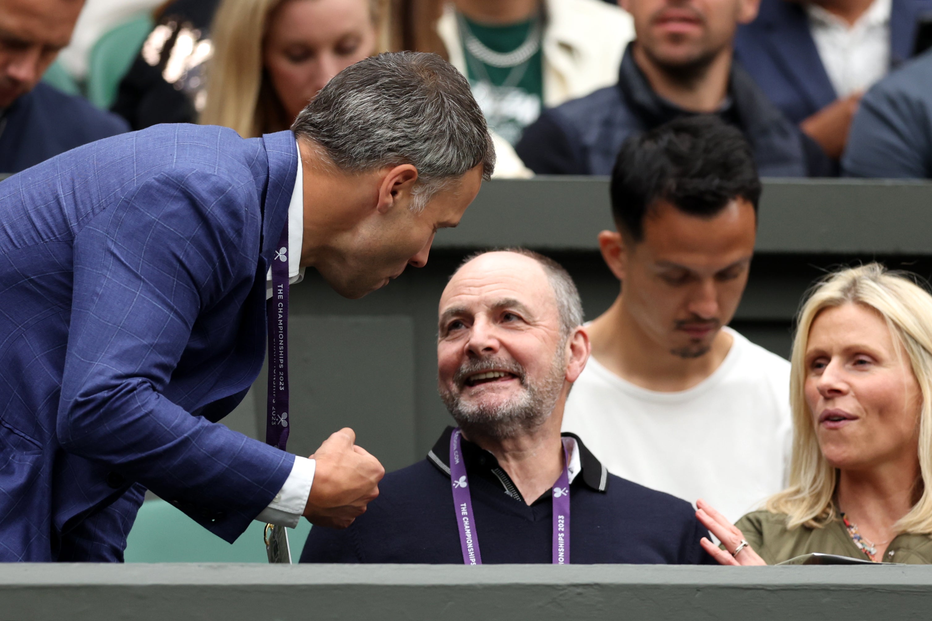William Murray (seated) talks to his son’s manager Matt Gentry at Wimbledon