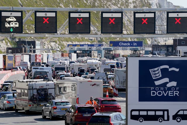 <p>Vehicles queue for ferries at the Port of Dover, Kent, where passengers are facing up to a two-hour wait for checks by French border officials</p>