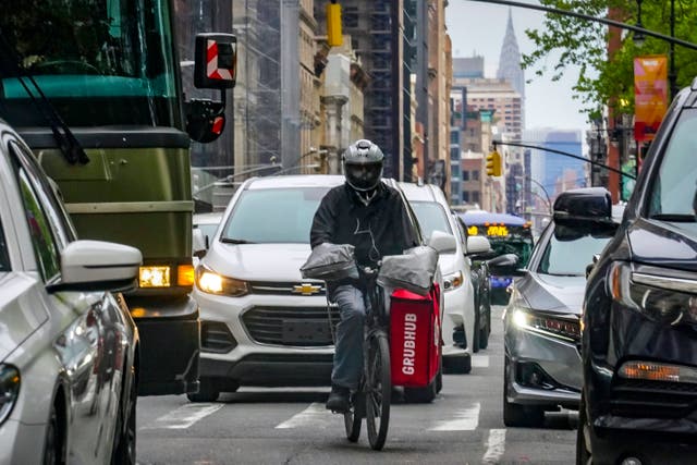 <p>A food delivery driver on the streets of New York earlier this year </p>