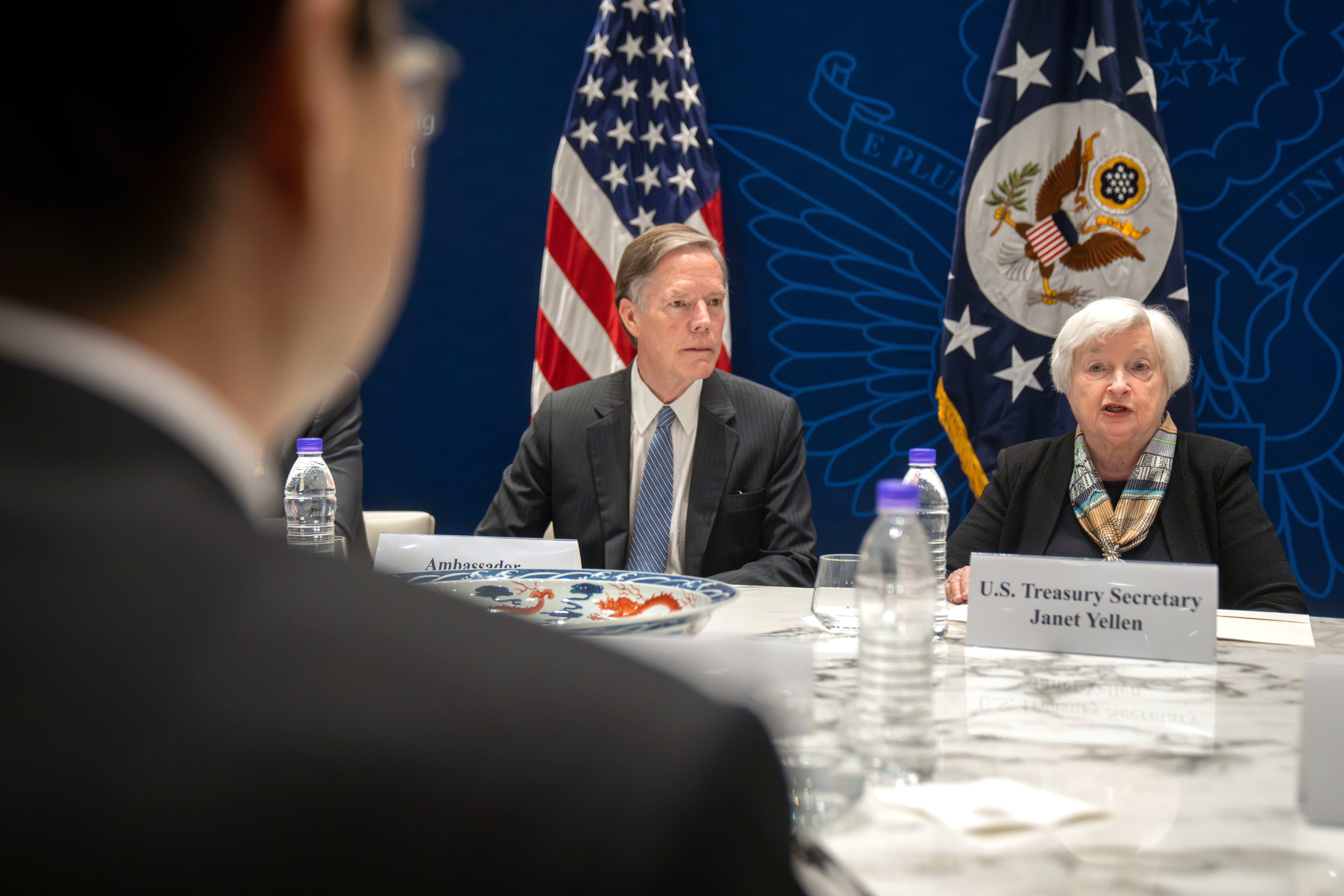 <p>US ambassador to China Nicholas Burns, centre, listens as the Treasury secretary speaks at a climate finance roundtable discussion at the US embassy in Beijing on Saturday </p>