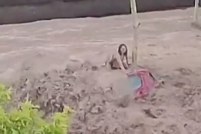 <p>Woman clings to roof of car during flash floods in Spain</p>