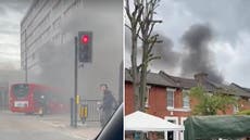 Towering plumes of black smoke pour out of huge east London fire