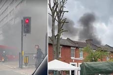 Towering plumes of black smoke pour out of huge east London fire