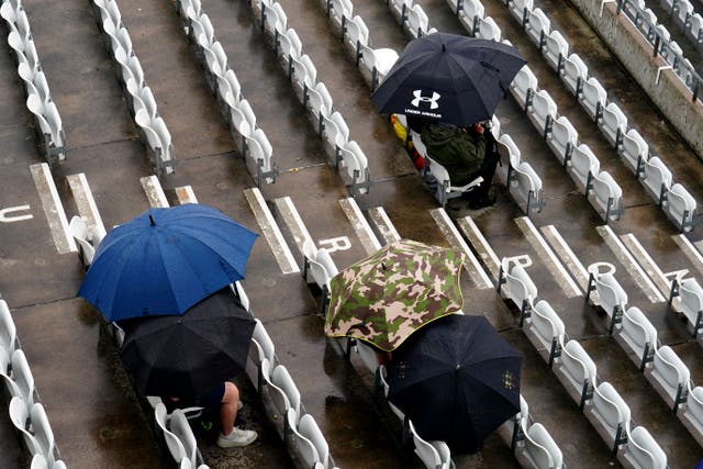 Spectators shelter from the rain at Headingley (Mike Egerton/PA)