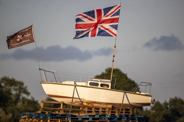 A boat flying the Union flag placed on the top of the pyre with a banner that reads ‘No Irish Sea border’