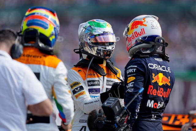 Red Bull’s Max Verstappen (right) is congratulated, after taking pole position by McLaren’s Lando Norris (centre) (David Davies/PA)