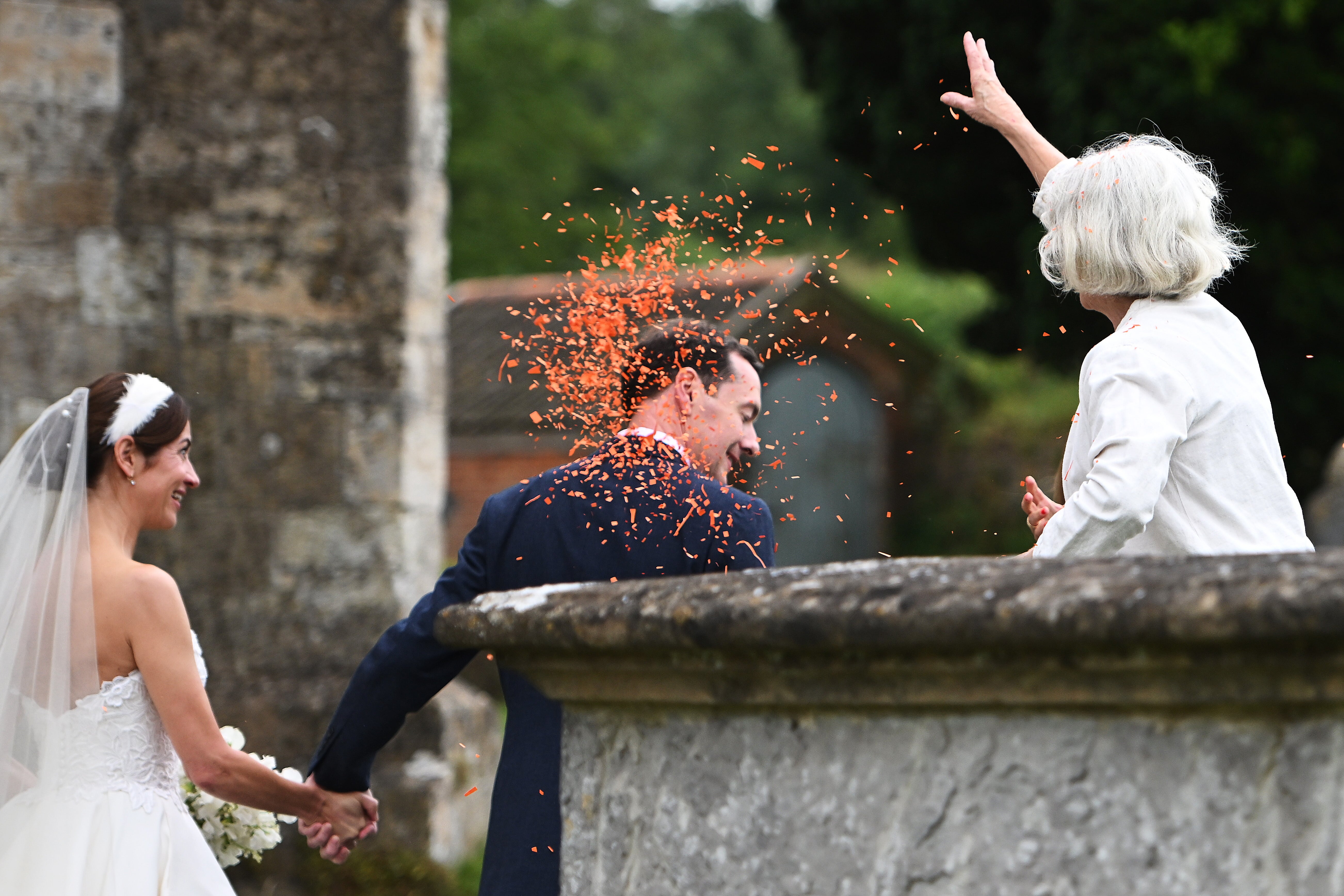 The newlyweds were showered in orange confetti