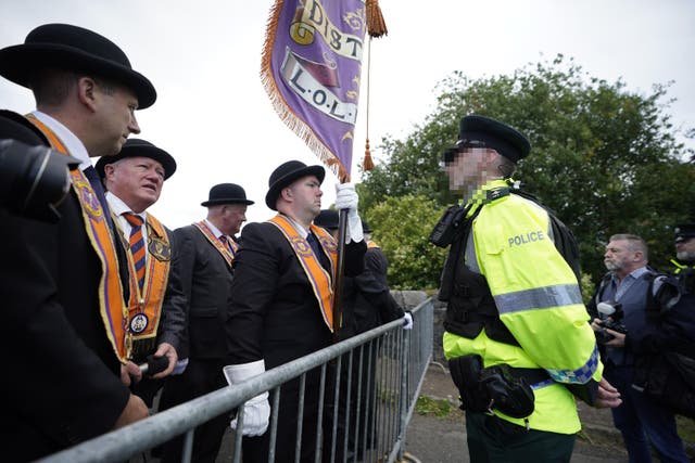 Orange Order members at a barrier during the Drumcree parade in Portadown, Co Armagh (Niall Carson/PA)