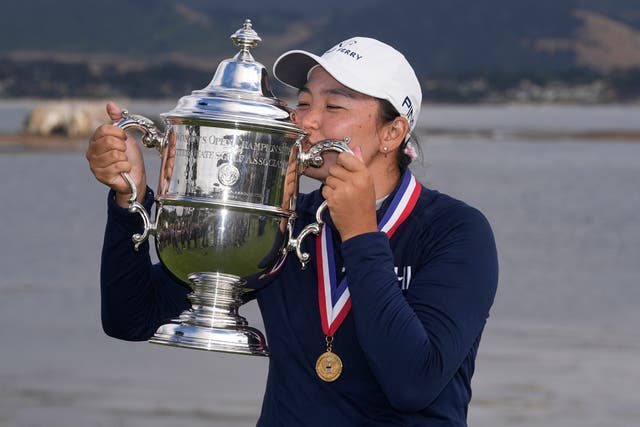 Allisen Corpuz kisses the winner’s trophy after the US Women’s Open golf tournament at Pebble Beach (Darron Cummings/AP)