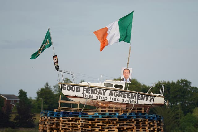 A pyre with a boat on top, with a picture of Taoiseach Leo Varadkar and a banner that reads ‘Good Friday Agreement? That ship has sailed’, before it is set alight in Moygashel, Co Tyrone (Niall Carson/PA)