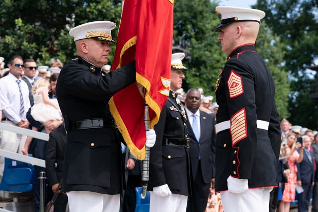 <p>US Marine Corps Gen David Berger, left, holds the battle colors during a relinquishment of office ceremony, Monda</p>