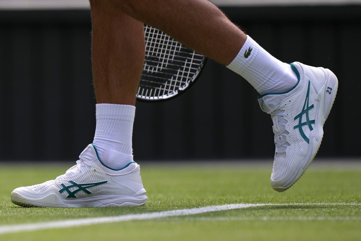 Novak Djokovic plays at Wimbledon with the number '23' printed on his ...