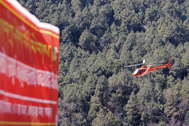 <p>A file image shows a rescue helicopter flying in Olangchung Gola in Nepal</p>