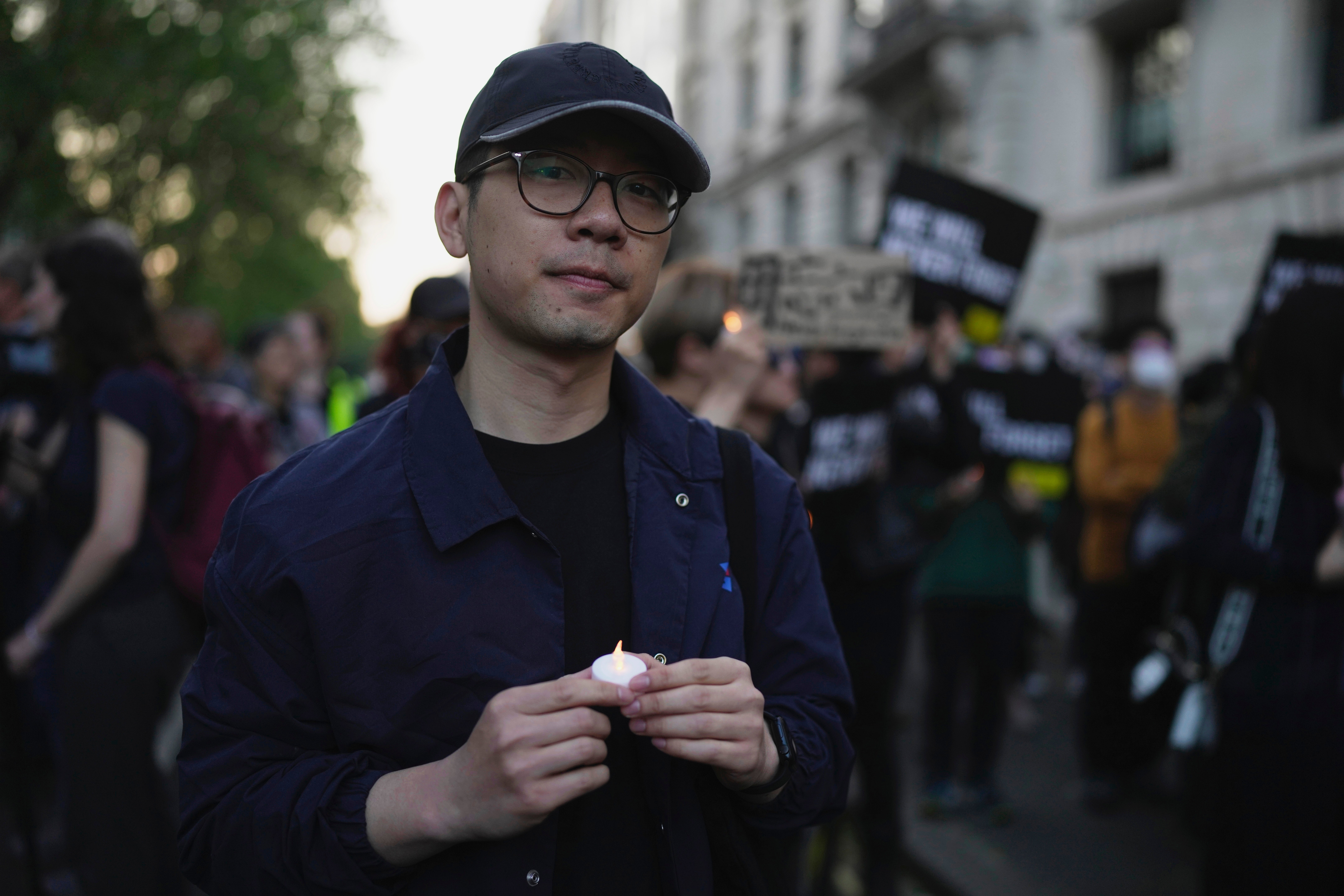 Hong Kong activist Nathan Law attends a candlelight vigil outside the Chinese embassy in London on 4 June