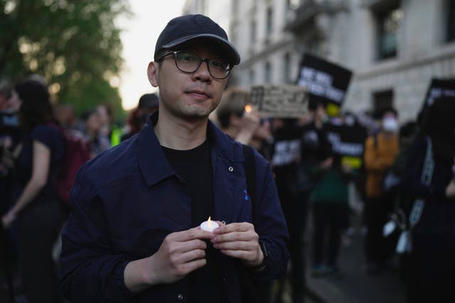 <p>Hong Kong activist Nathan Law attends a candlelight vigil outside the Chinese embassy in London on 4 June</p>
