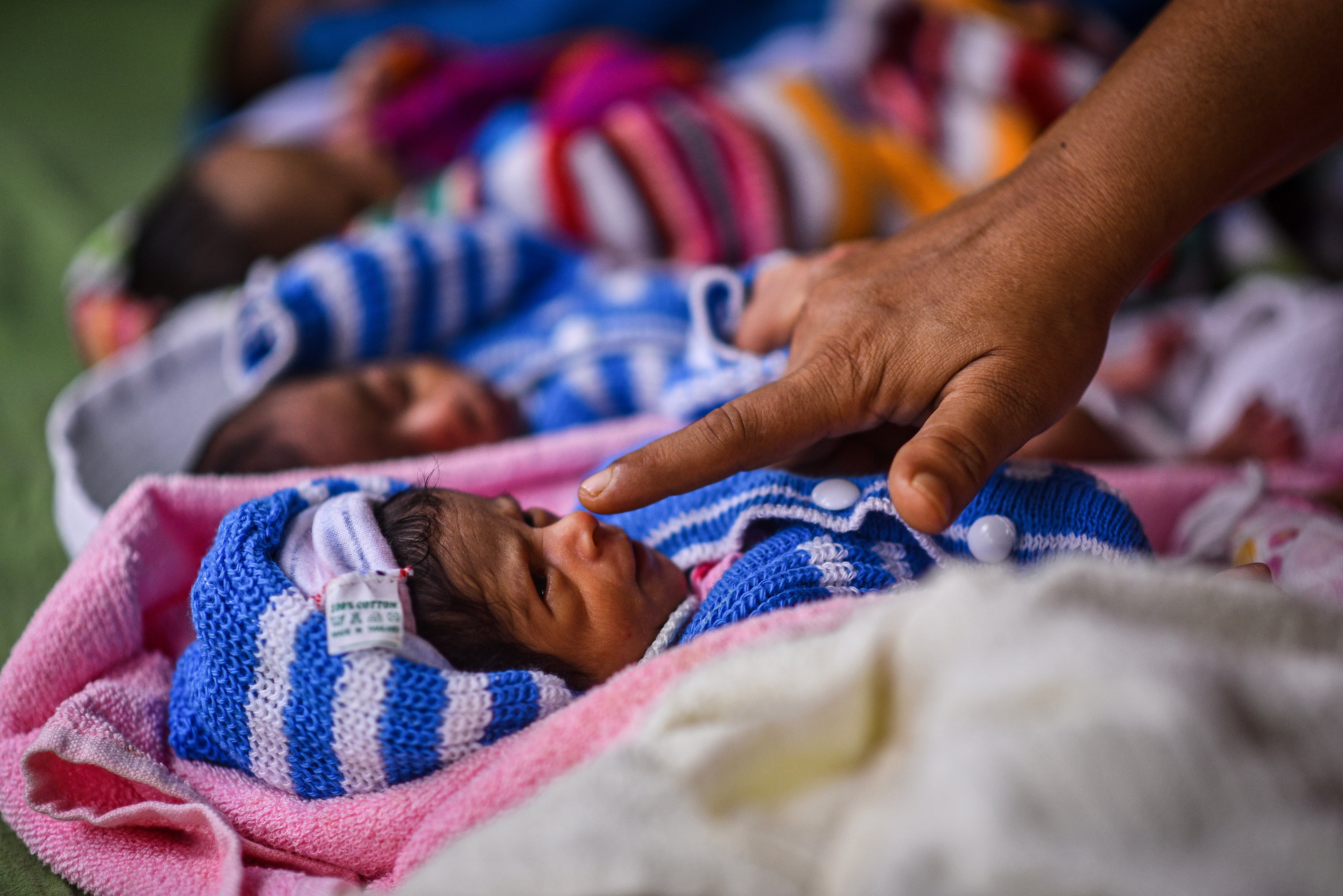 Newborn babies rest inside a government maternity hospital in Chennai, India