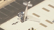 Small plane wedged nose-first into hangar roof after pilot crashes at California airport