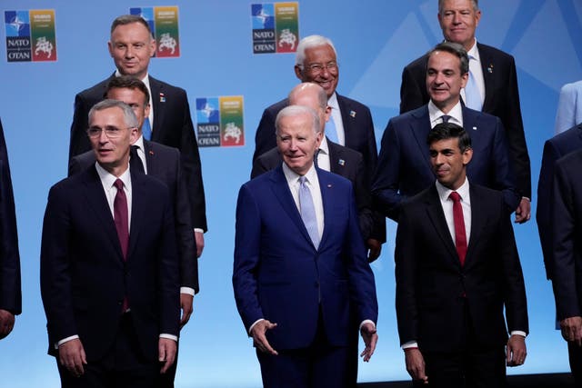 <p>Front row from left, NATO Secretary General Jens Stoltenberg, President Joe Biden, and Britain's Prime Minister Rishi Sunak, second row from left French President Emmanuel Macron, German Chancellor Olaf Scholz, and Greek Prime Minister Kyriakos Mitsotaki, third row from left are, Polish President Andrzej Duda, Portugal's Prime Minister Antonio Costa and Romania's President Klaus Werner Iohannis, reacts at the conclusion of the family photo at the NATO summit in Vilnius, Lithuania, Tuesday, July 11, 2023.</p>