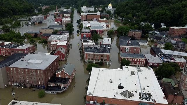 <p>A still from drone footage of city blocks flooded in Montpelier, Vermont </p>