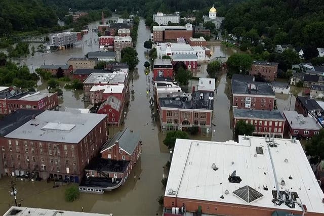 <p>A still from drone footage of city blocks flooded in Montpelier, Vermont </p>