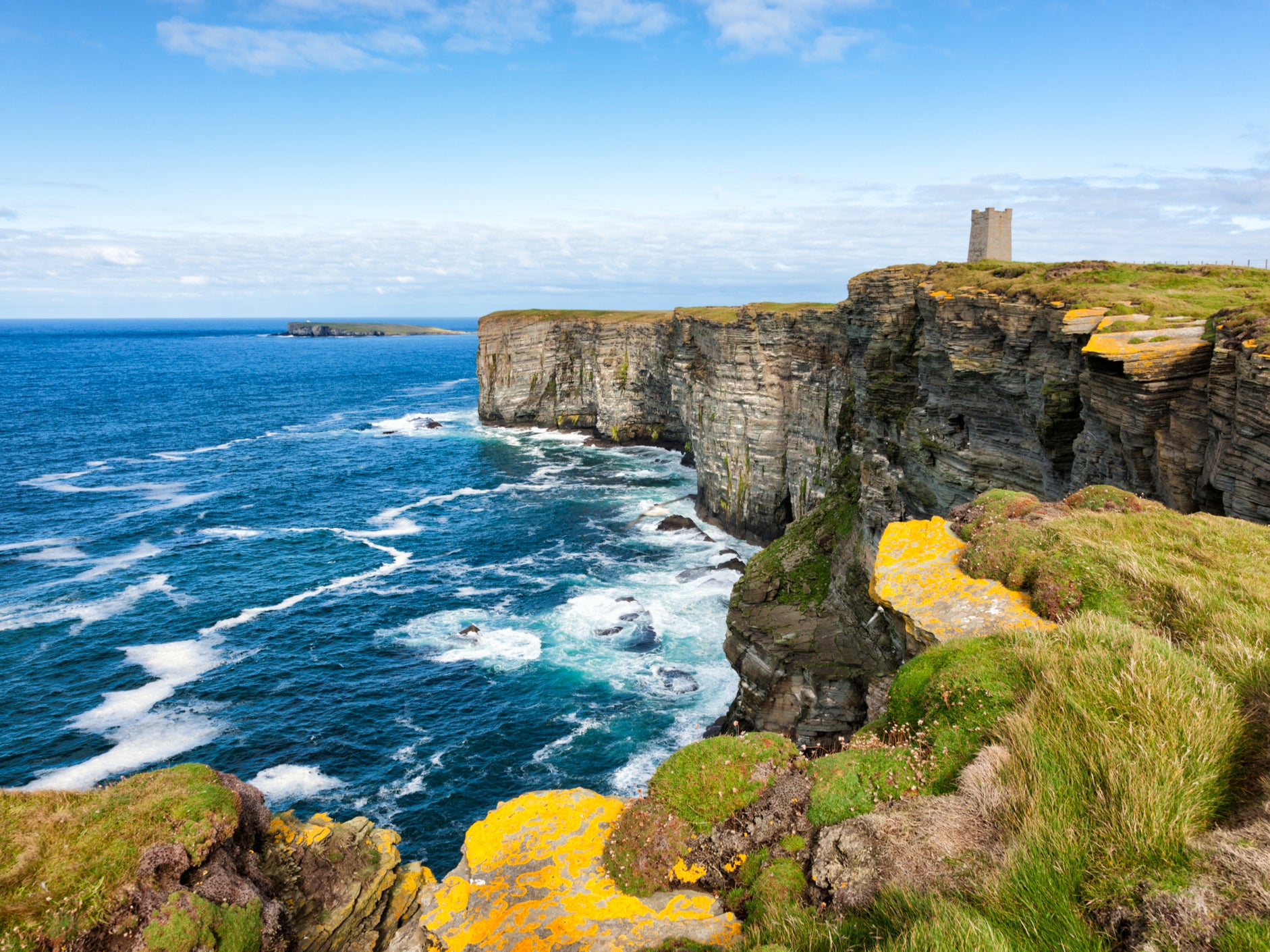 A rugged coastline whipped by ocean winds are synonymous with Orkney