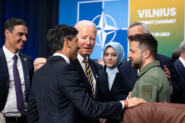 <p>British Prime Minister Rishi Sunak, front, U.S. President Joe Biden, center, and Ukraine's President Volodymyr Zelenskyy, left, speak during a meeting of the NATO-Ukraine Council at the level of Heads of State and Government, with Sweden, at the NATO Summit in Vilnius, Lithuania, Wednesday, July, 12, 2023. (Doug Mills/Pool via AP)</p>