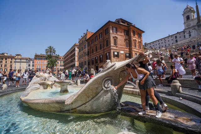<p>People cool off in the Barcaccia fountain today as Rome experiences high temperatures  during a heatwave which are expected to reach  above 40C</p>