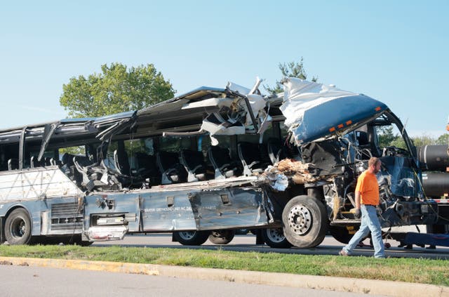 <p>A worker helps clear the wreckage of a Greyhound bus that collided with tractor-trailers on the exit ramp to a rest area on westbound Interstate 70 in Highland, Ill., on Wednesday, July 12, 2023.</p>