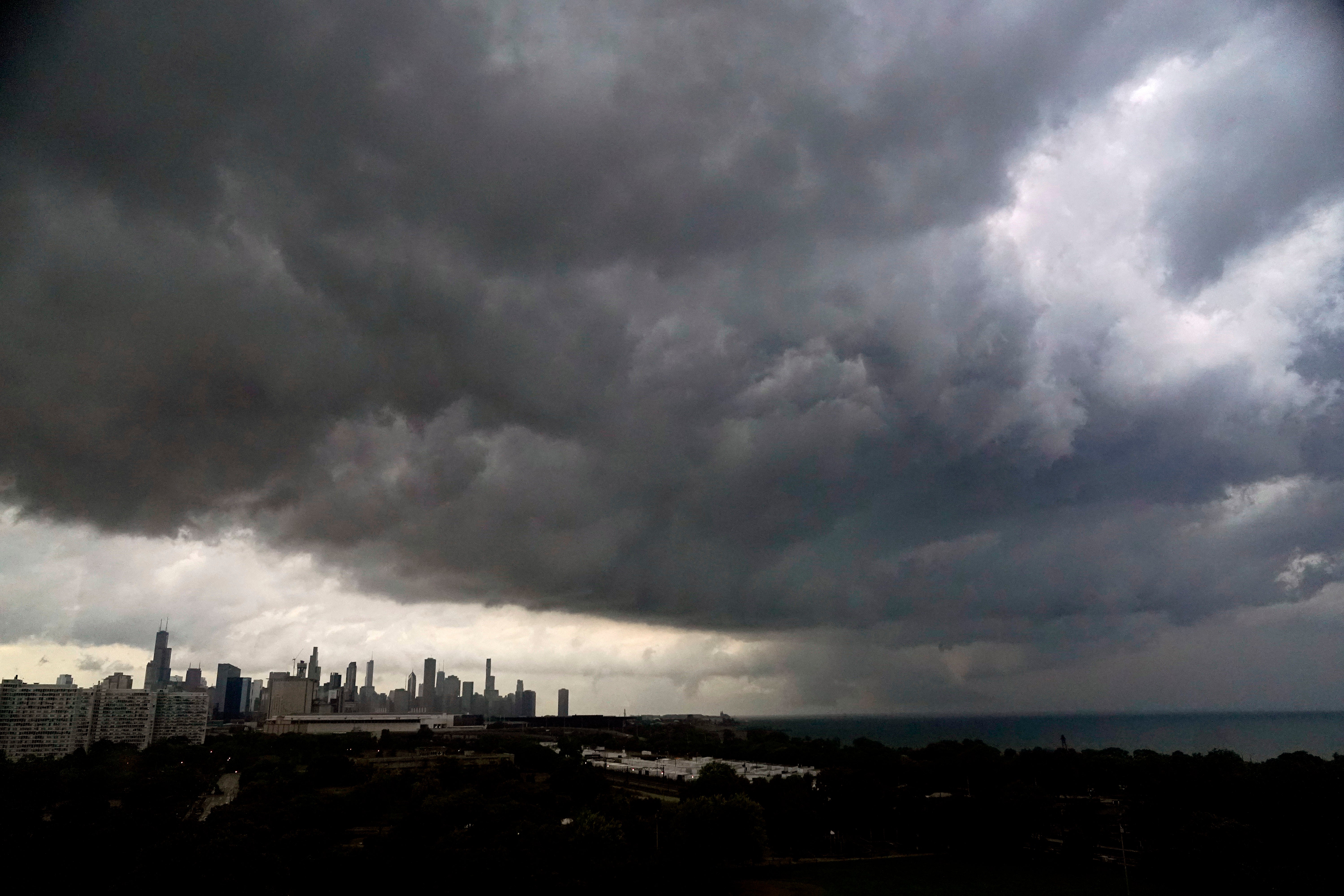 Storm clouds pass over downtown Chicago and the Bronzeville neighborhood of the city heading East out over Lake Michigan