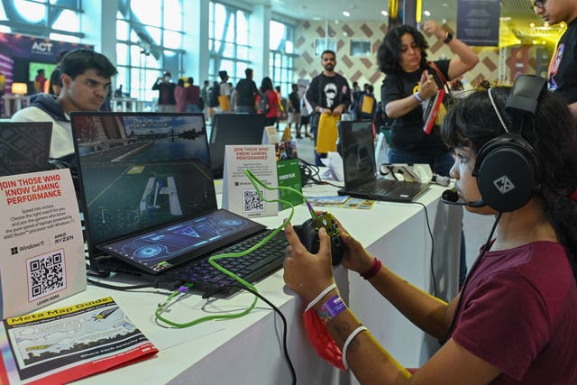 <p>A visitor plays ac computer game during the opening day of the two-day comic book and cosplay characters convention ‘Bengaluru Comic Con 2022’ in Bengaluru on November 19, 2022</p>