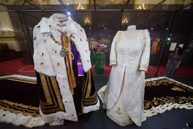 The King and Queen’s coronation ensembles on display at Buckingham Palace for the summer opening (Yui Mok/PA)