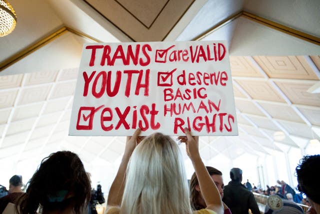 <p>Hunter Schafer, of Raleigh, holds a sign supporting transgender youth during a special session of the North Carolina General Assembly  </p>